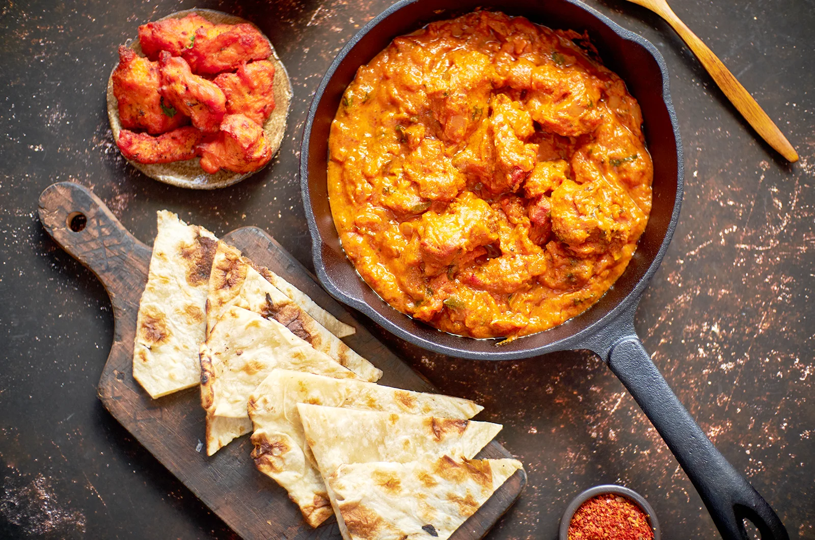 Tikka Masala cooked in a mild and creamy tandoori red sauce served with naan