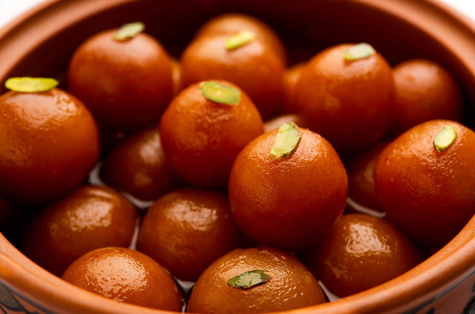 Gulab Jamun arranged in a red pot