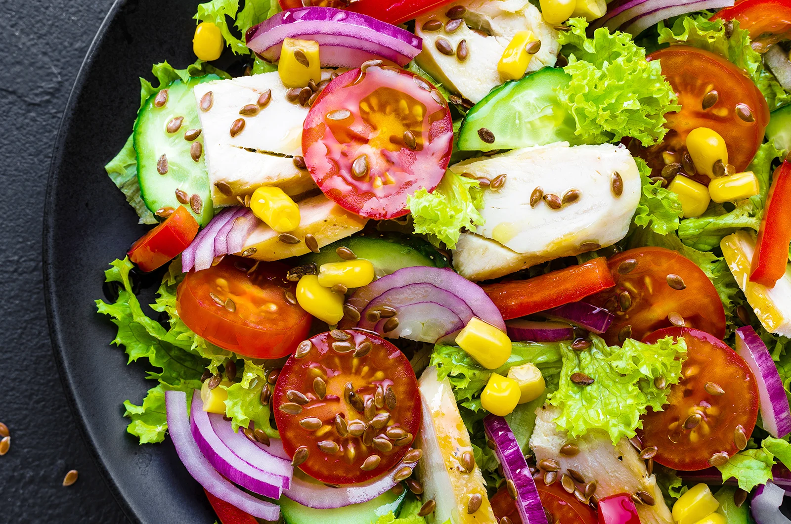 fresh green salad with tomato, mixed greens on a plate