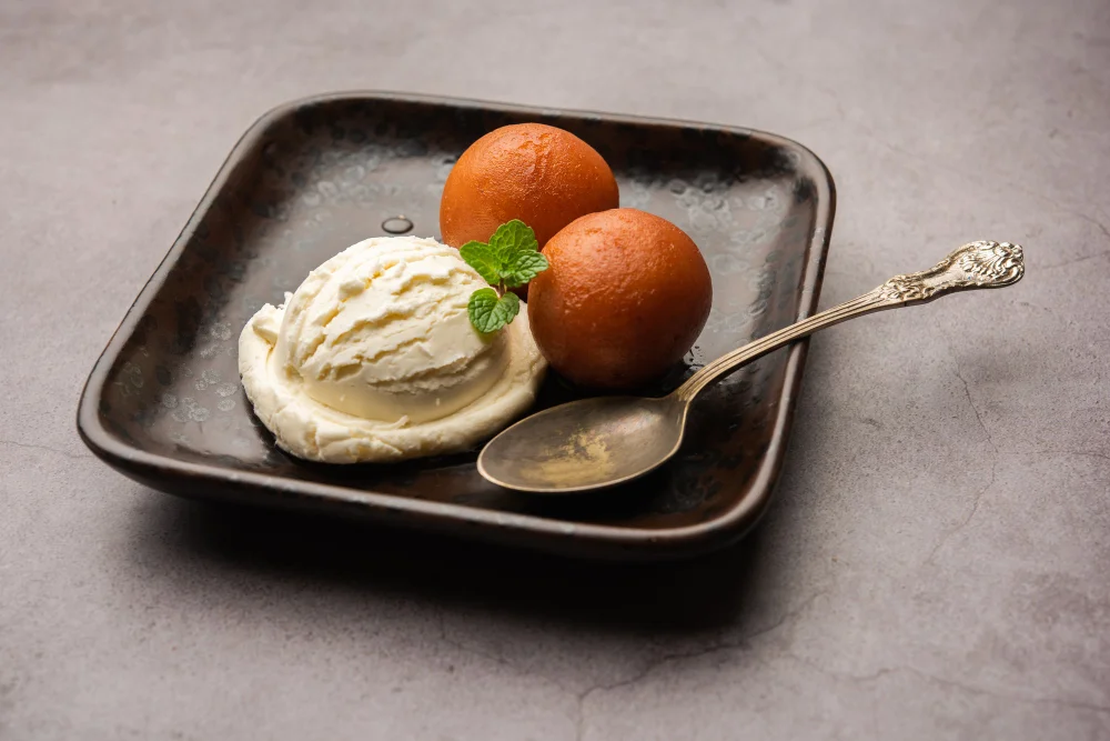 Gajjar Halwa with Ice Cream served on a plate with a spoon