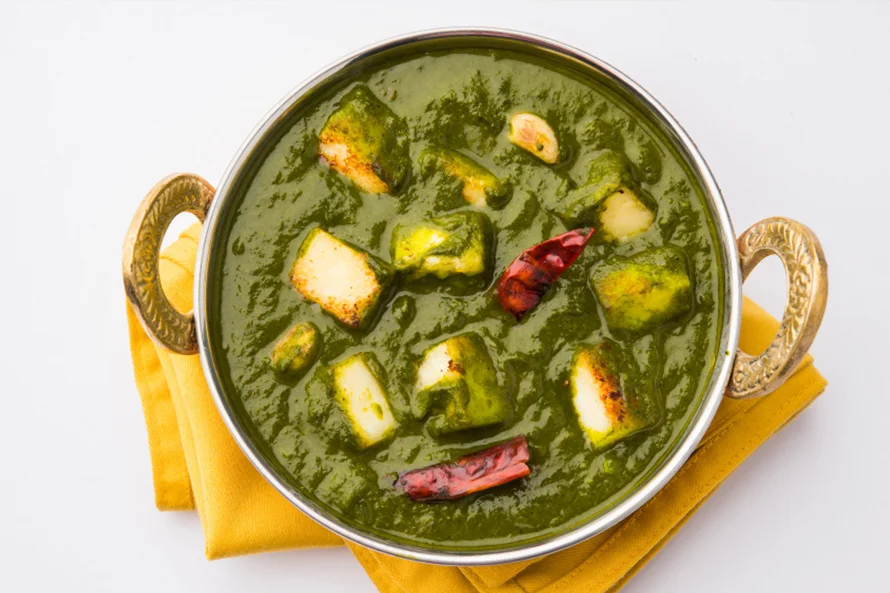 Palak Paneer with cubes of paneer in creamy spinach curry